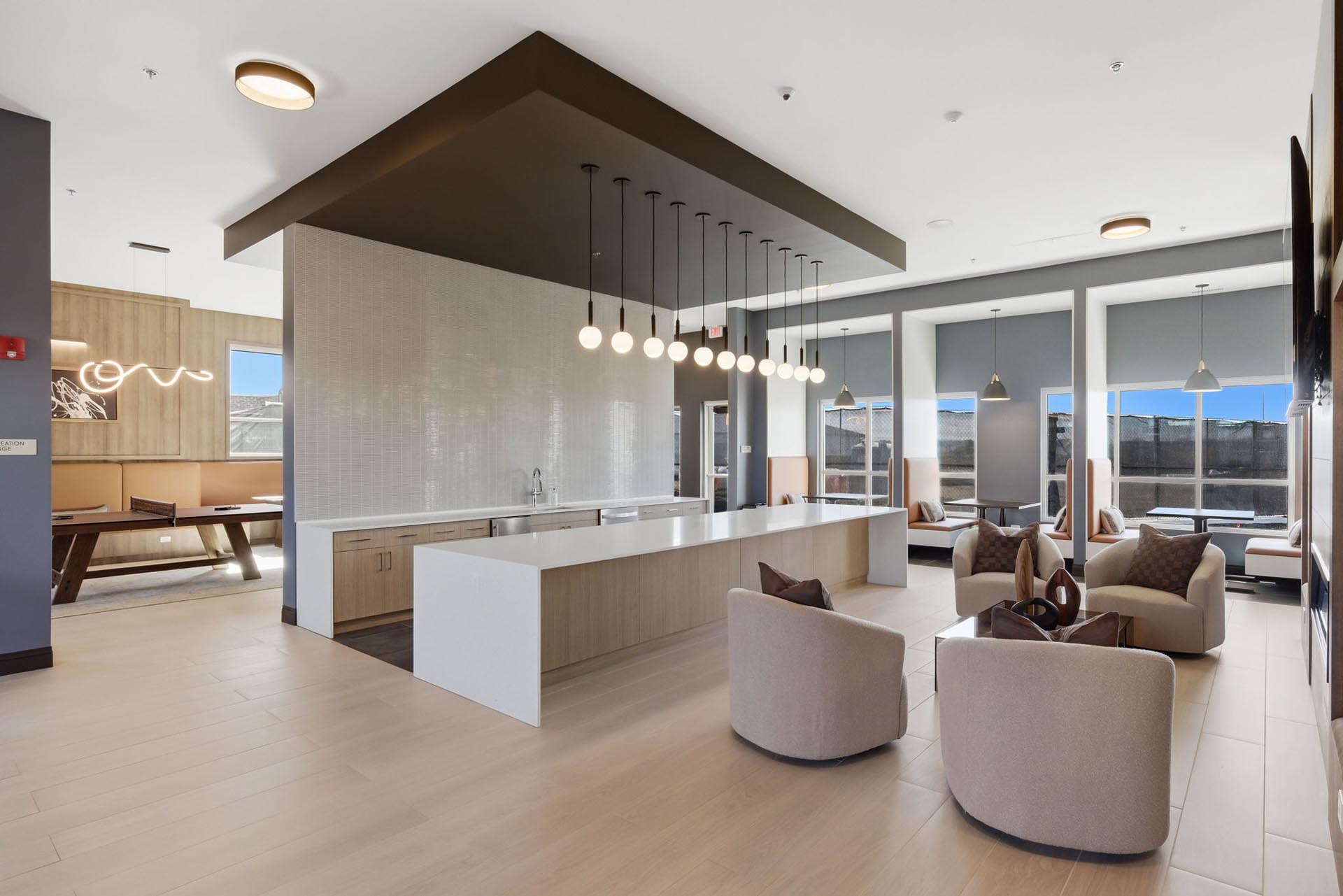 interior rendering of an apartment clubhouse with two pool tables and many windows