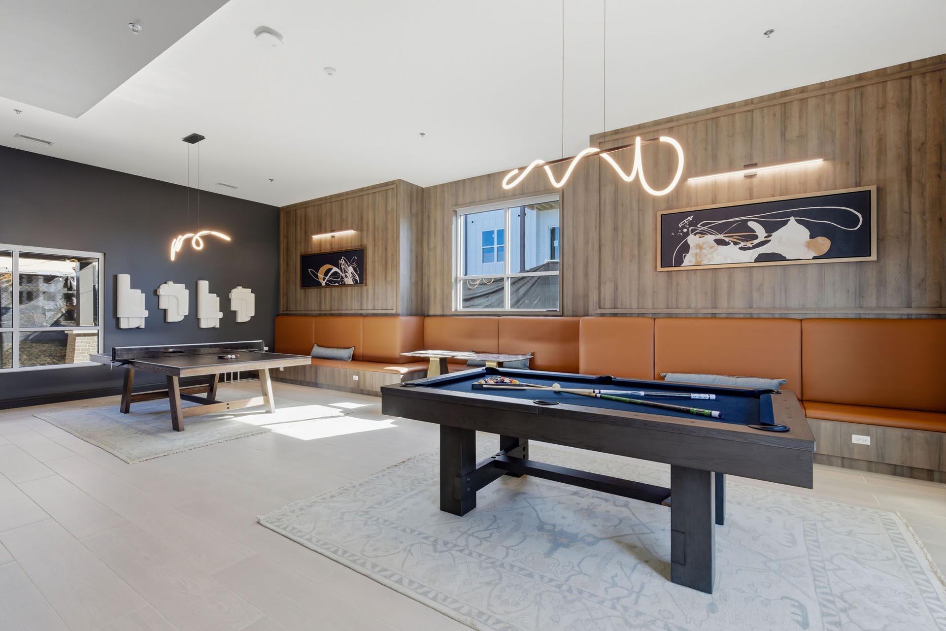 interior rendering of an apartment clubhouse with two pool tables and many windows